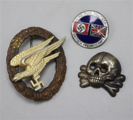 A German enamel war badge, a cap skull and a paratrooper badge, make G.W.L.